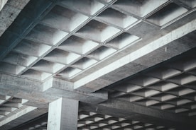 the underside of an overpass with a stop sign