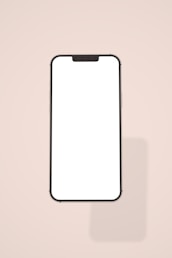 a white phone with a black frame on a pink background