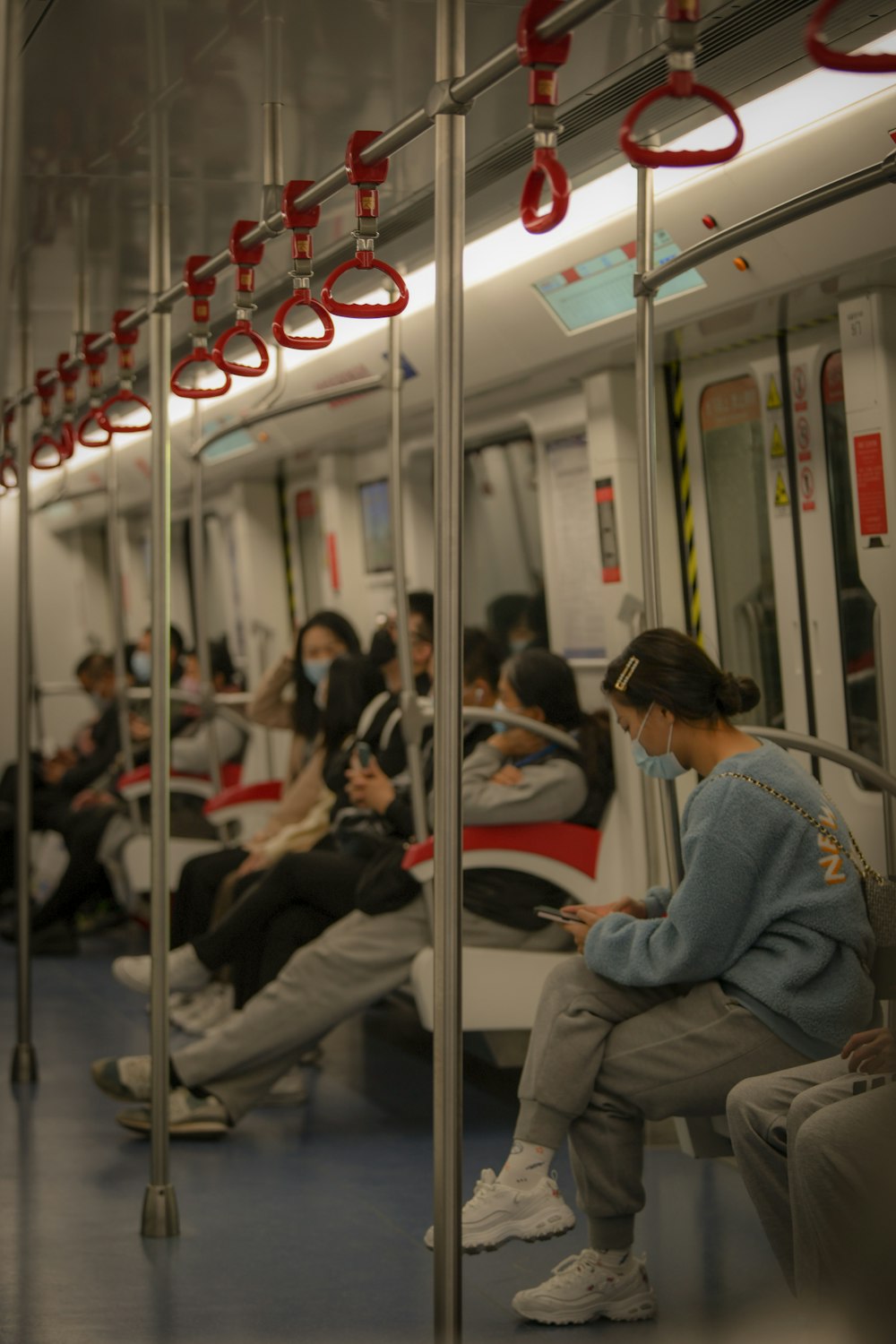 a group of people sitting on a train next to each other