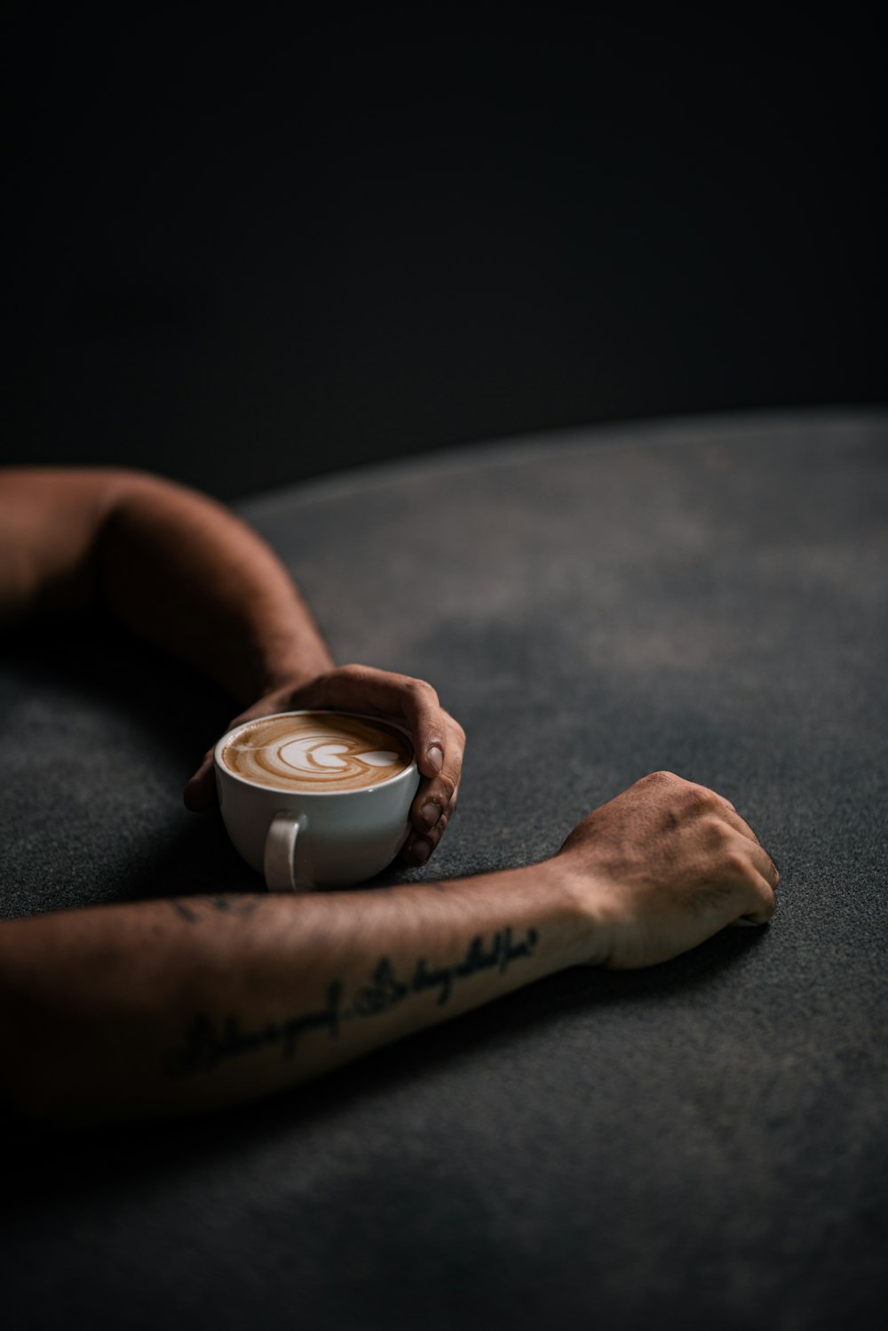 a close up of a hand holding a cup of coffee