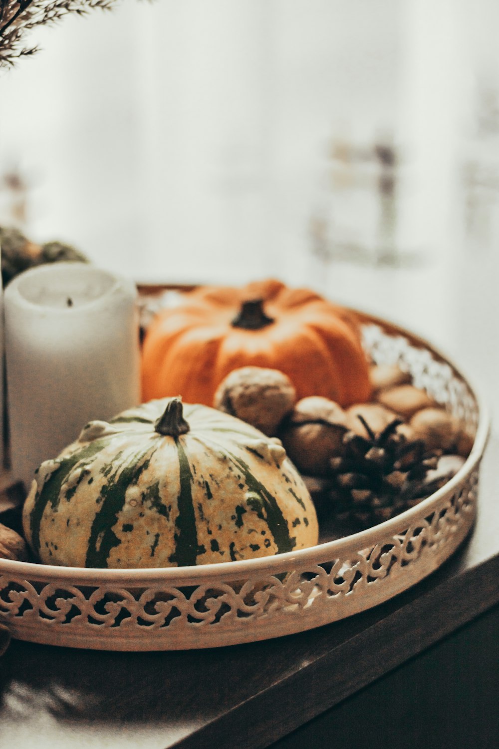 a basket filled with lots of different types of pumpkins