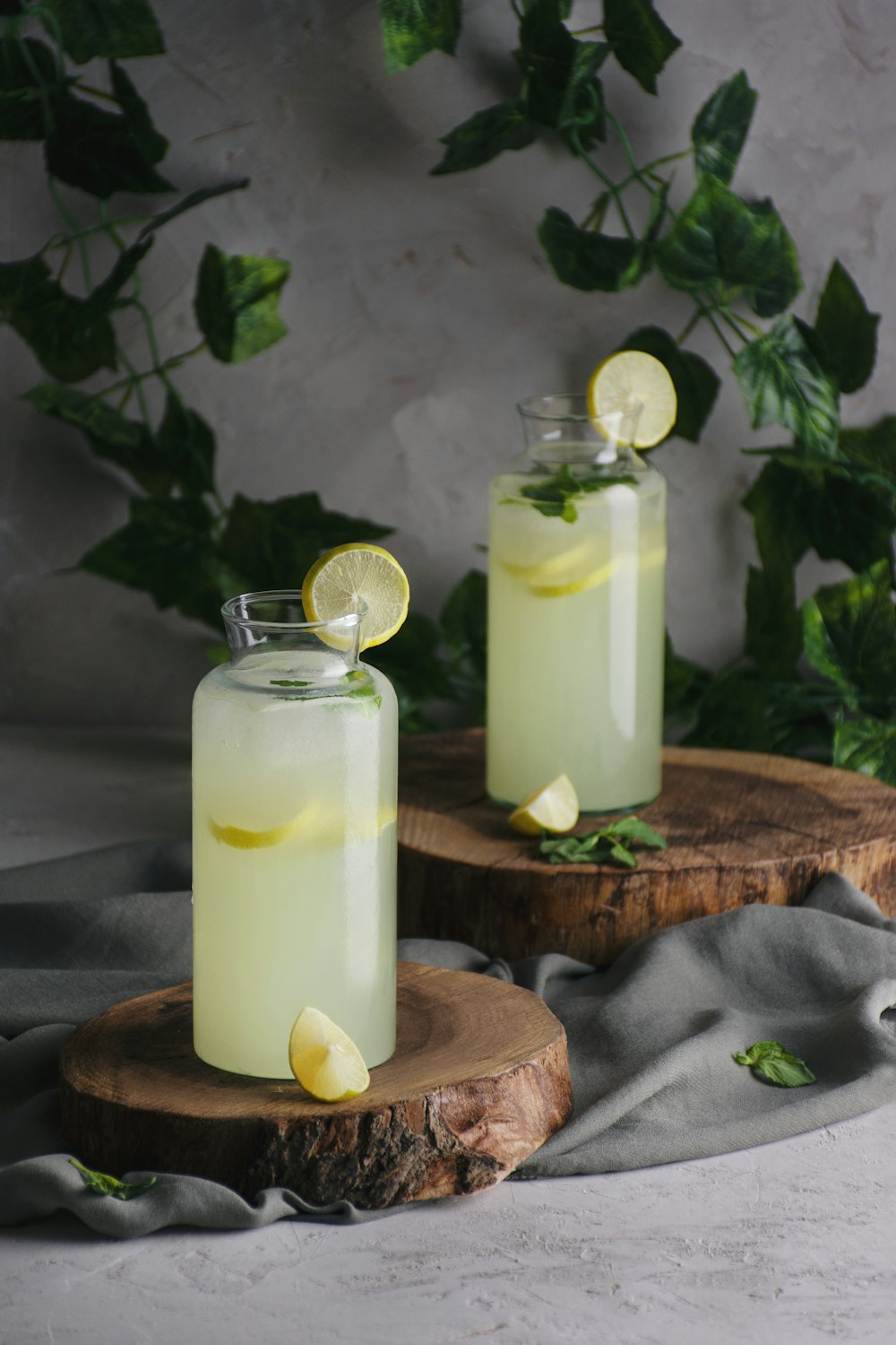 two glasses of lemonade with lemon slices