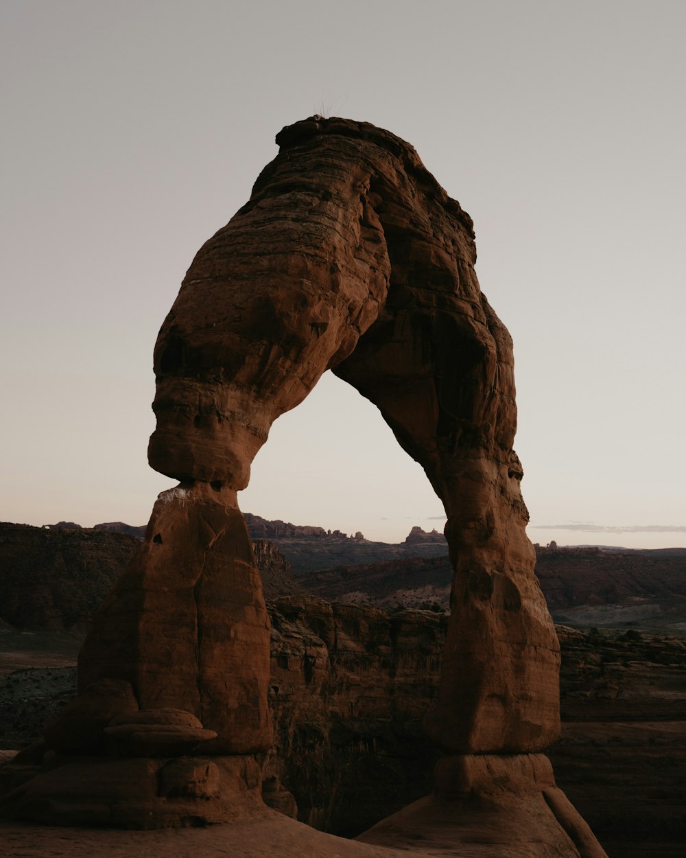 a large rock formation in the middle of a desert