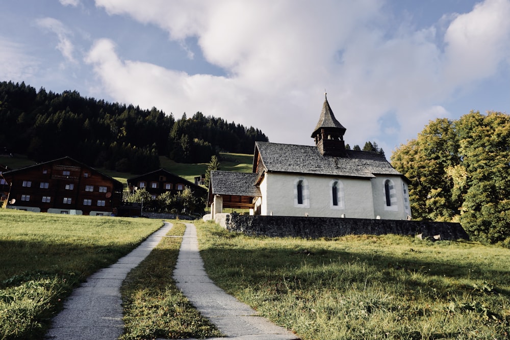 a small church in the middle of a grassy field