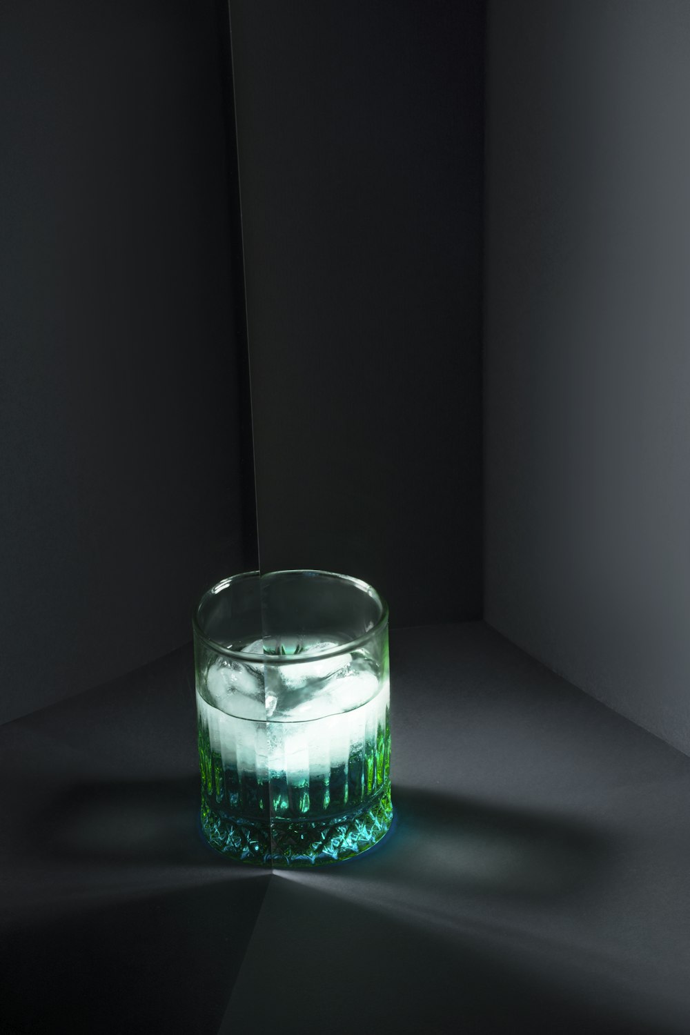 a glass filled with liquid sitting on top of a table