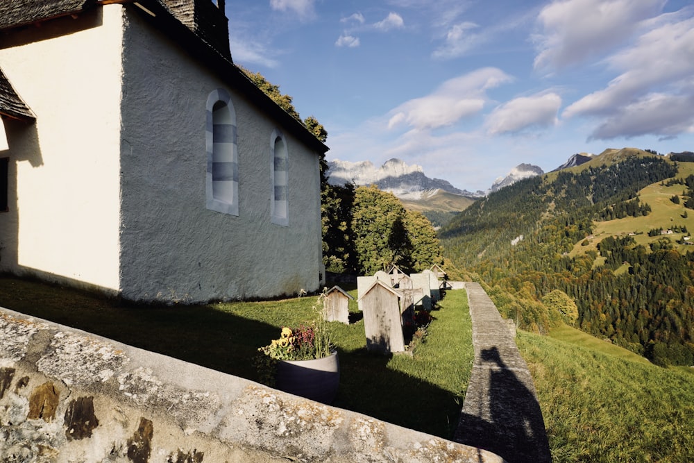 a small church in the middle of a grassy hill