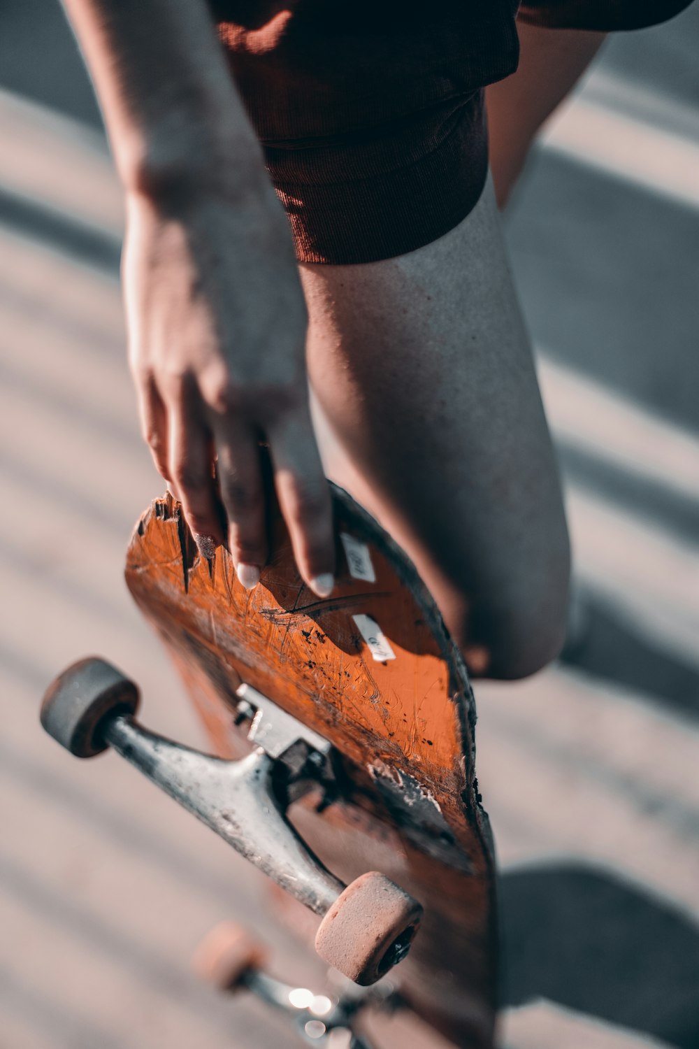 a person holding a skateboard in their hand