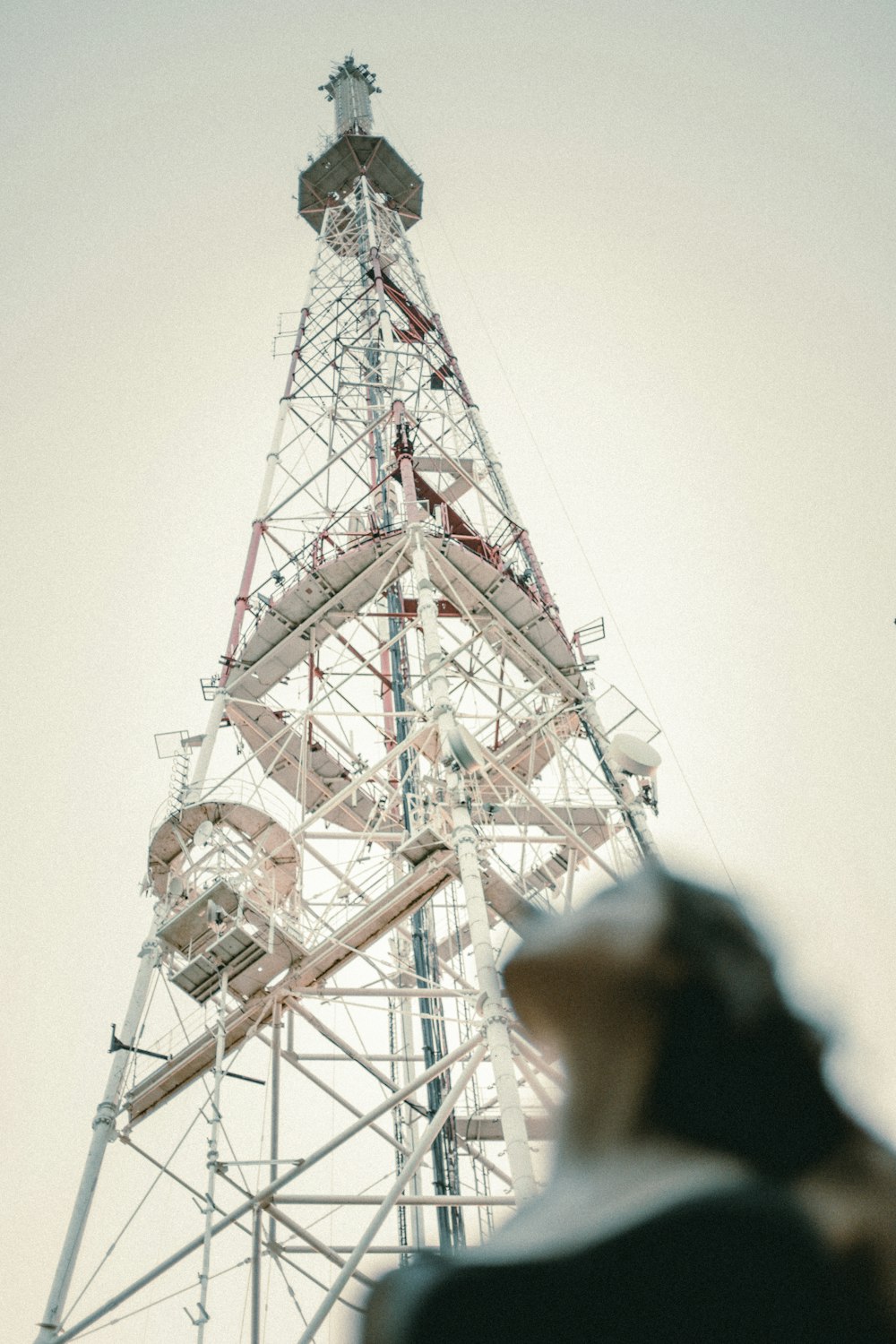 a man standing in front of a tall tower