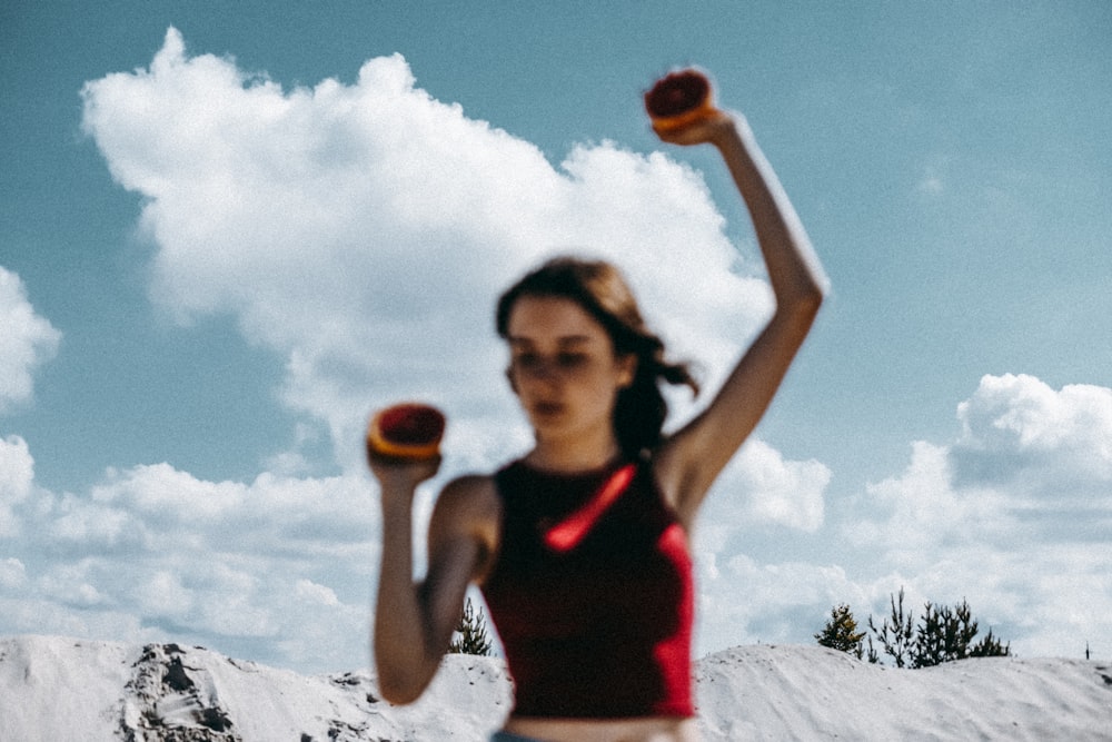 a woman holding two oranges in her hands