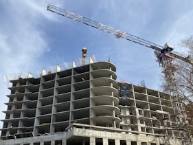 a crane is on top of a building under construction
