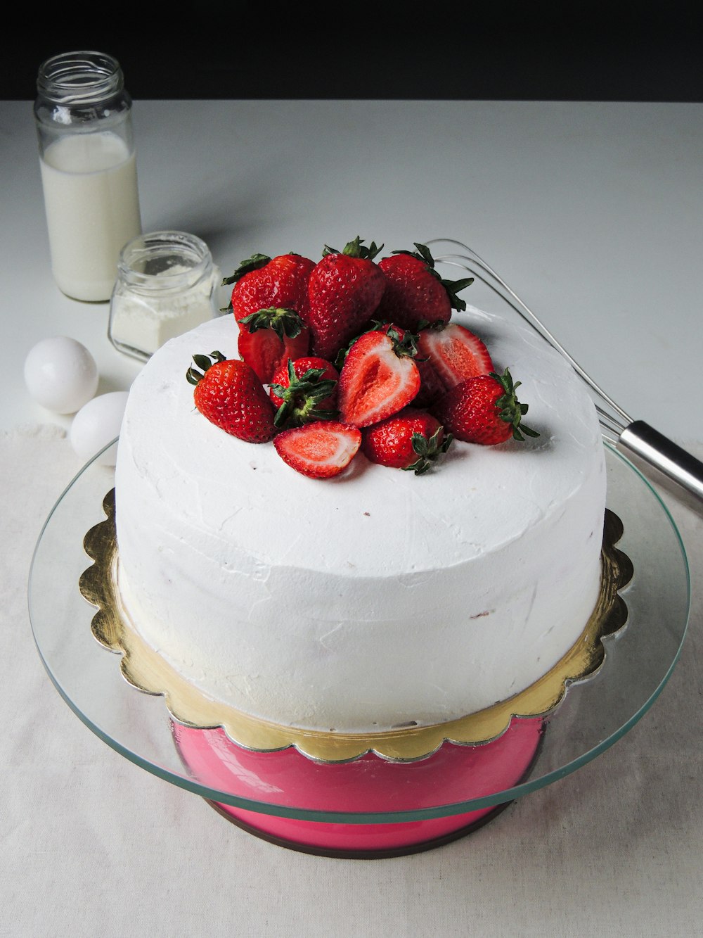 a white cake with strawberries on top of it