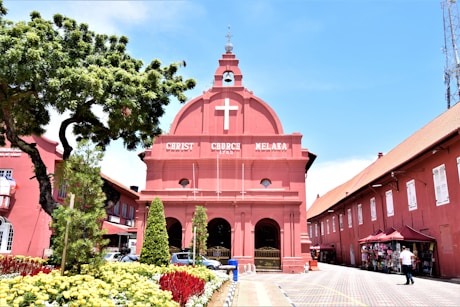a pink building with a cross on the top of it