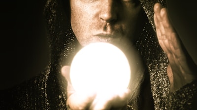 a man holding a glowing ball in his hand