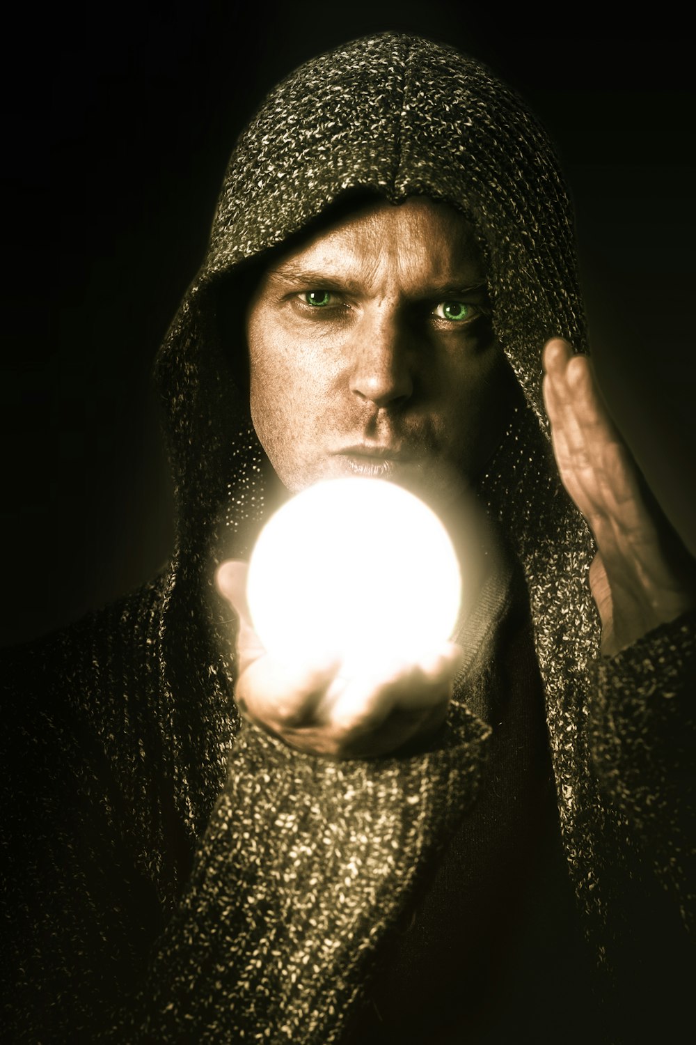 a man holding a glowing ball in his hand