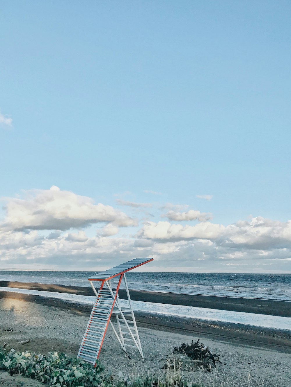 a ladder leaning up against the side of a beach