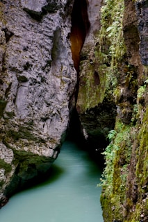 a narrow river running between two large rocks