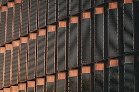 a tall building with lots of windows next to a clock