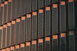 a tall building with lots of windows next to a clock