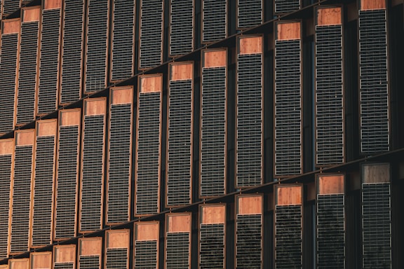 a tall building with lots of windows next to a clock
