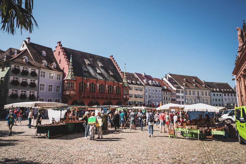 a group of people standing around a market