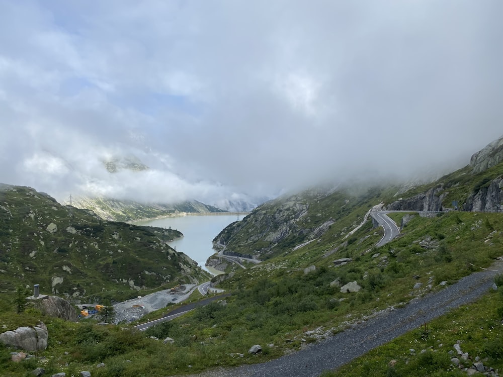 a scenic view of a lake and a road