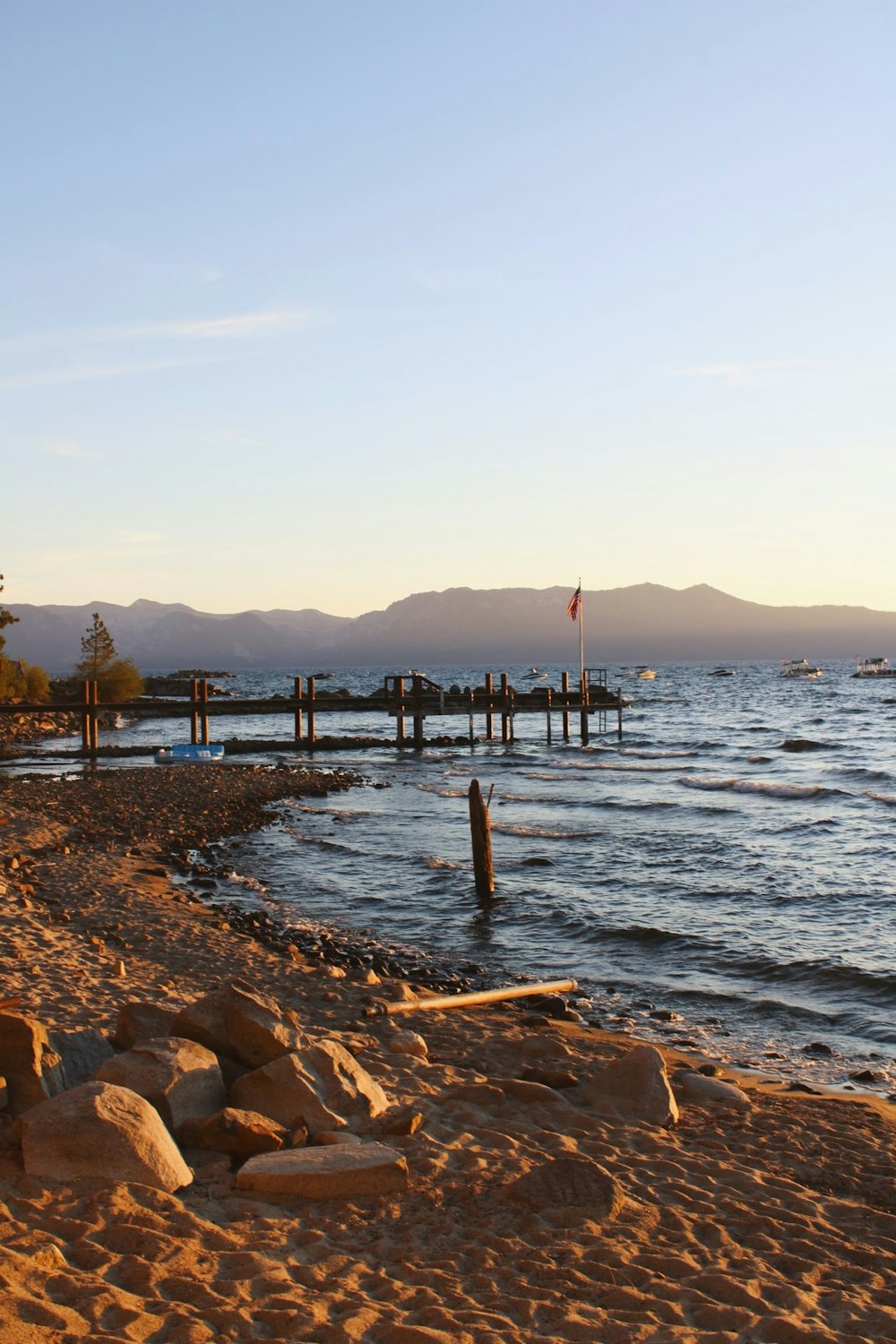 a body of water sitting next to a sandy beach