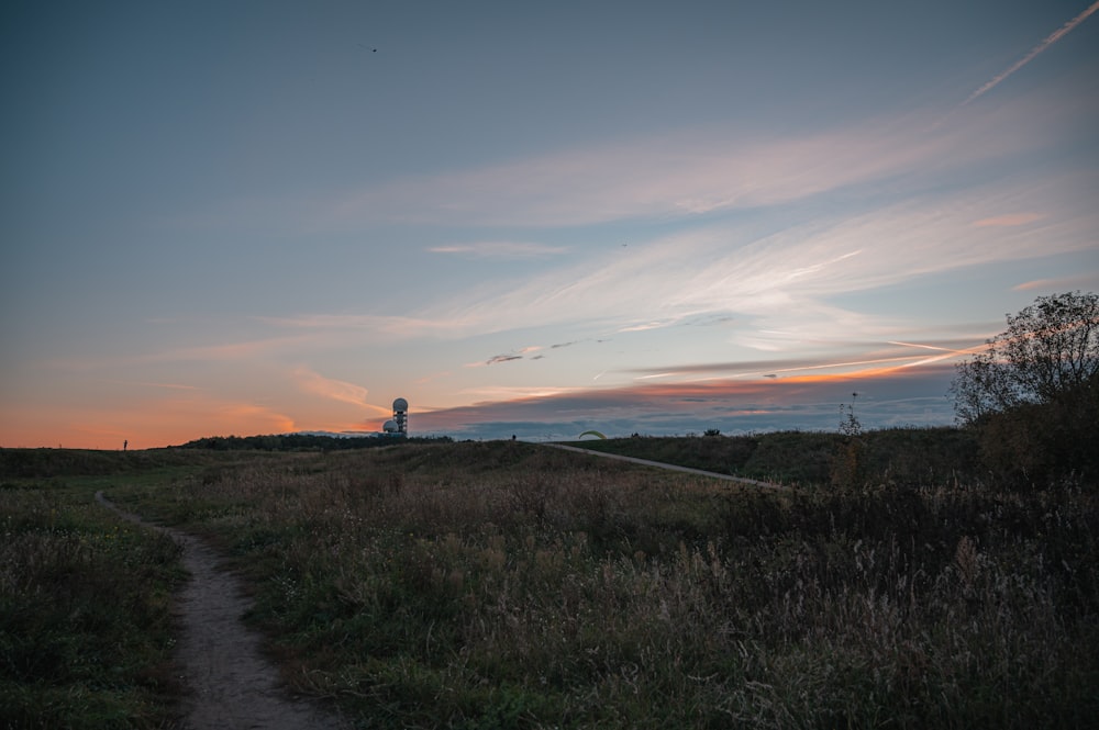 a path leading to a light house on a hill