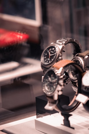 a couple of watches are on display in a glass case
