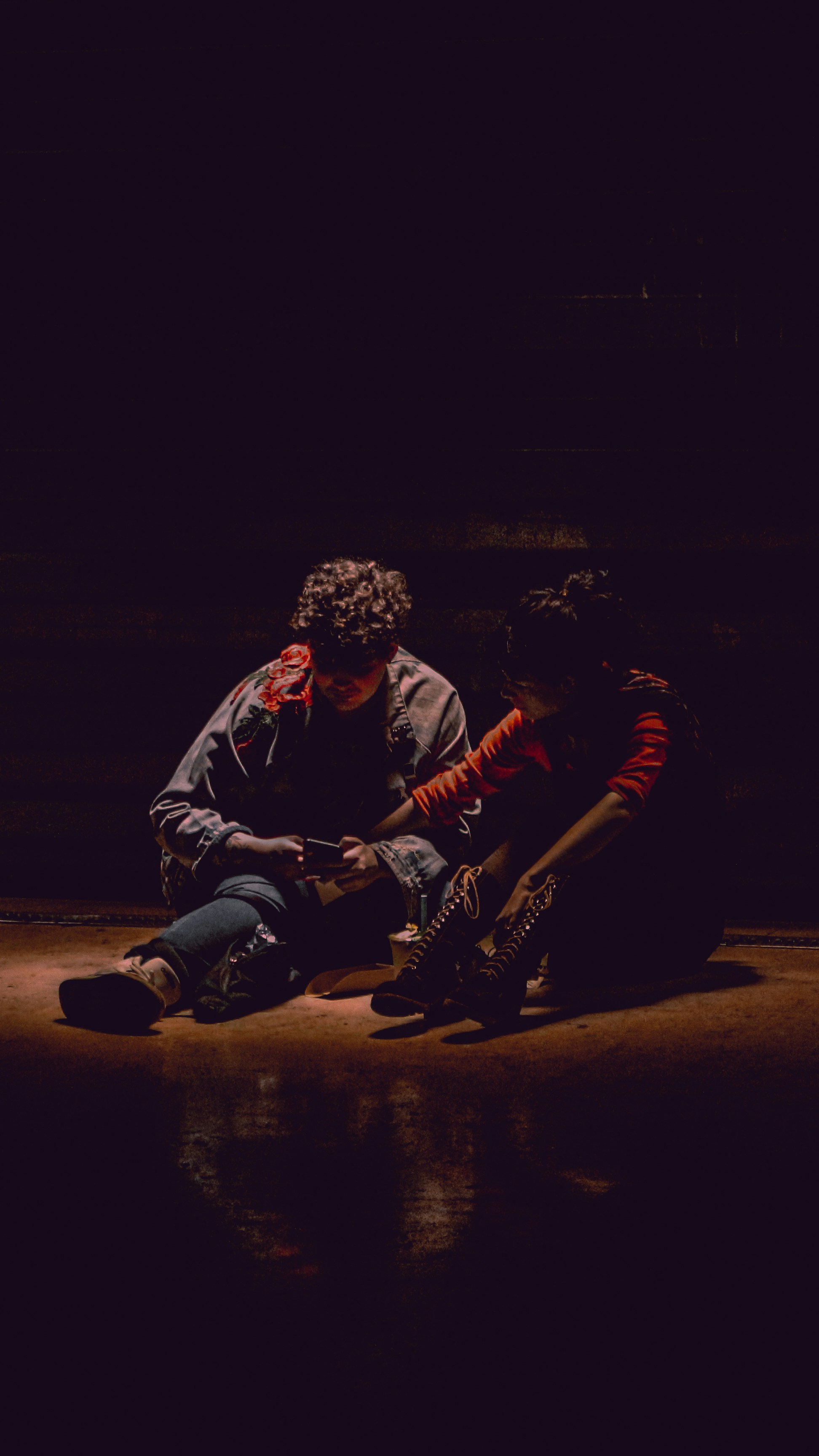 a couple of people sitting on the ground