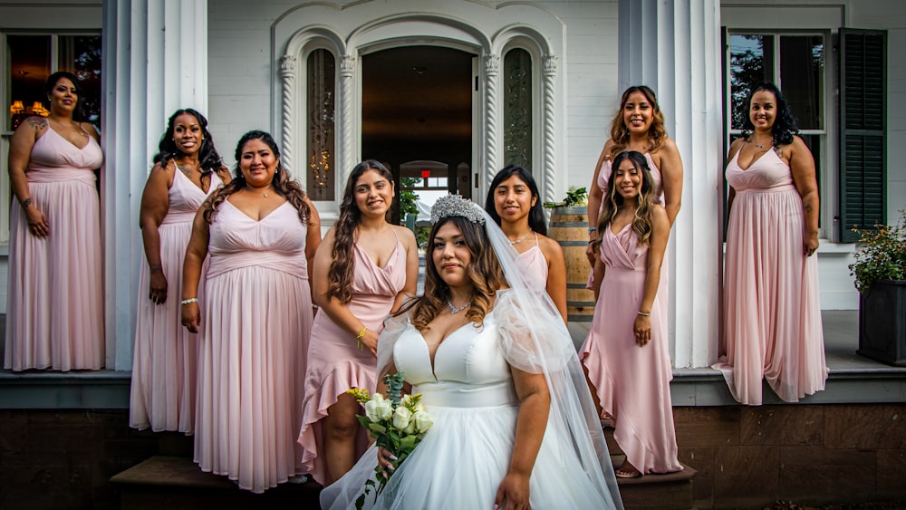 a bride and her bridesmaids posing for a picture
