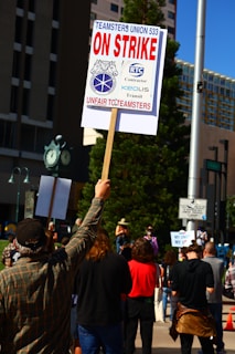 a man holding a sign in the middle of a crowd