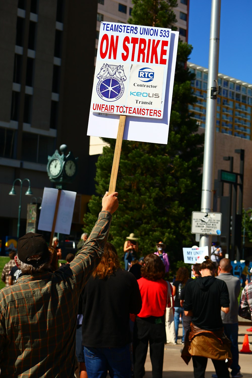 a man holding a sign in the middle of a crowd