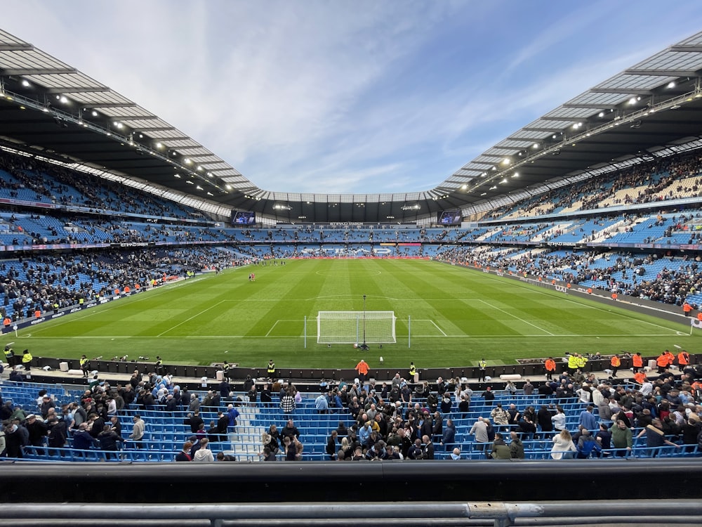 a stadium filled with lots of people watching a soccer game