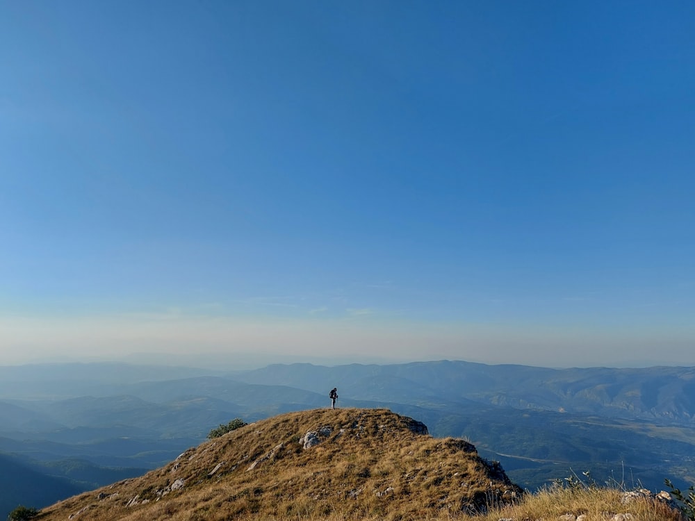 a person standing on top of a hill