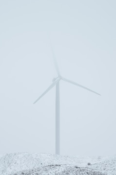 a wind turbine on a snow covered hill
