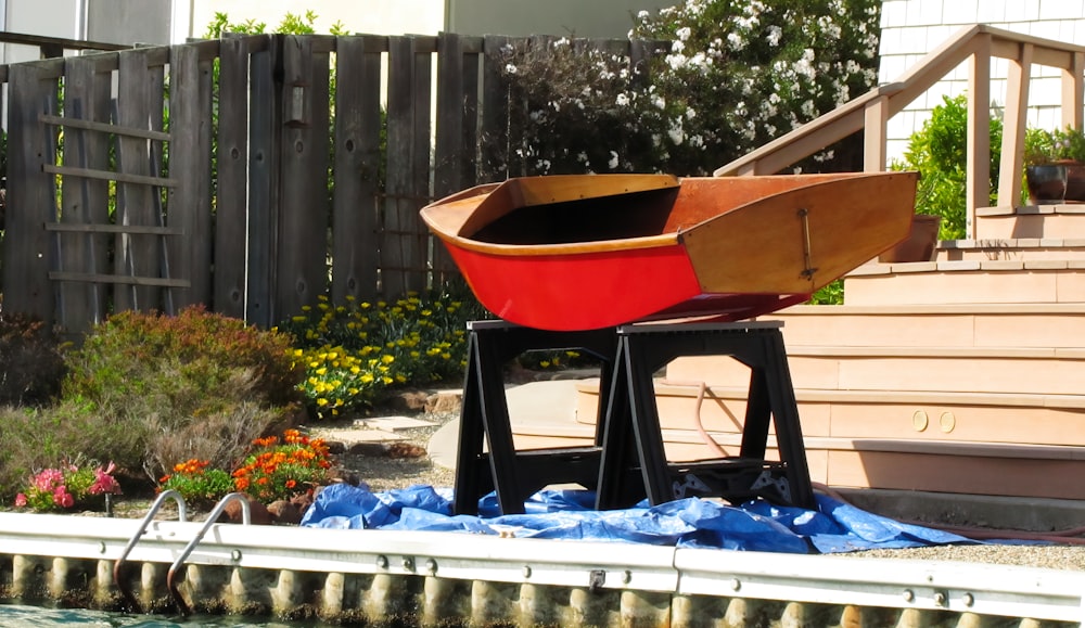 a boat sitting on top of a wooden stand