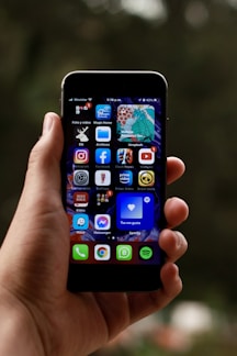 a person holding a smart phone in their hand