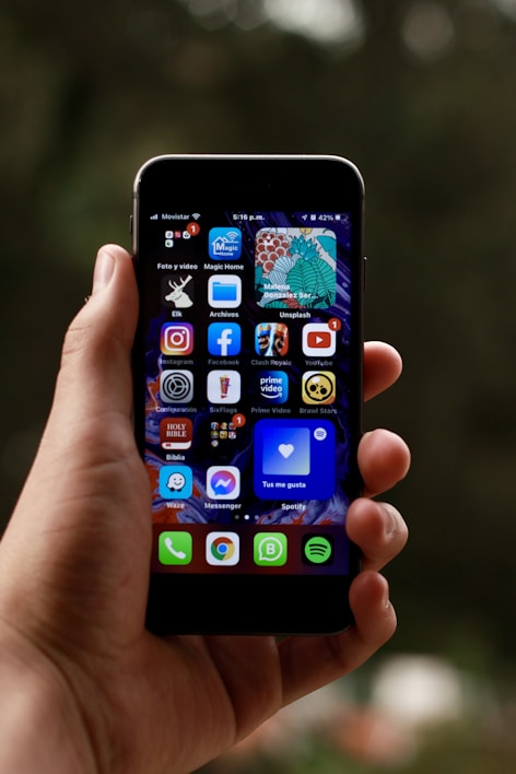 a person holding a smart phone in their hand