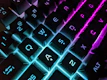 Close-up of a mechanical keyboard with neon blue backlight on black background