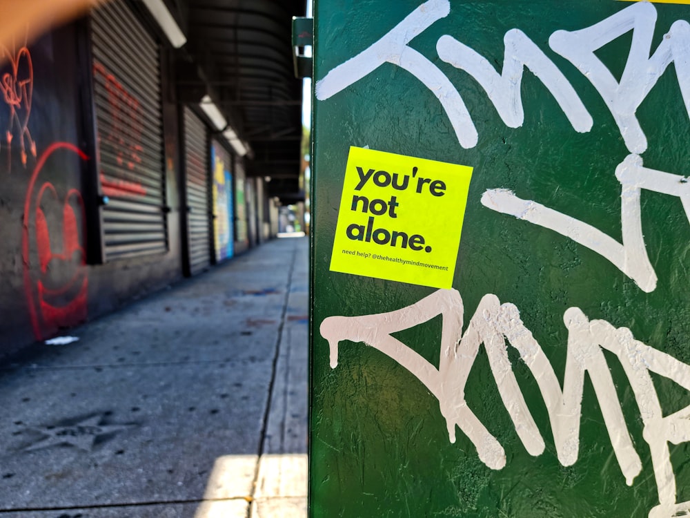 a green box with some graffiti on it