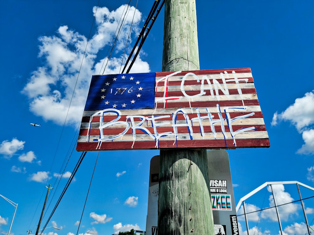 a wooden pole with a sign that says come to breathe