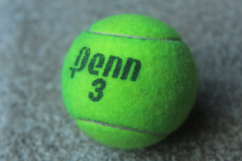 a green tennis ball with the number 3 on it