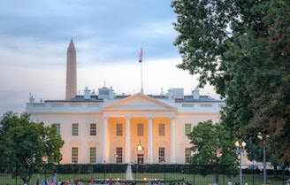a large white building with a flag on top of it