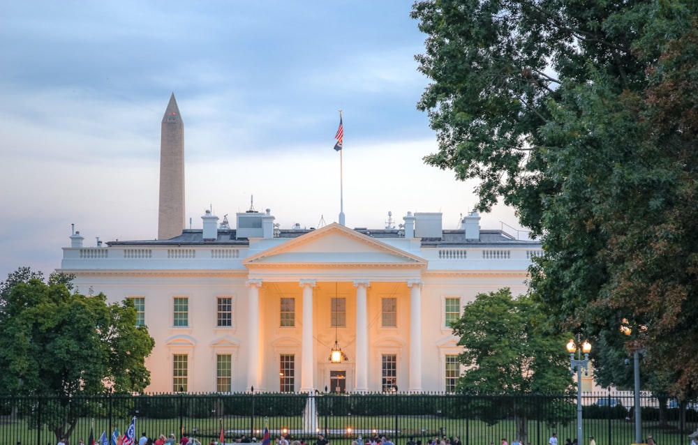 a large white building with a flag on top of it