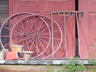 a large wheel sitting on the side of a building