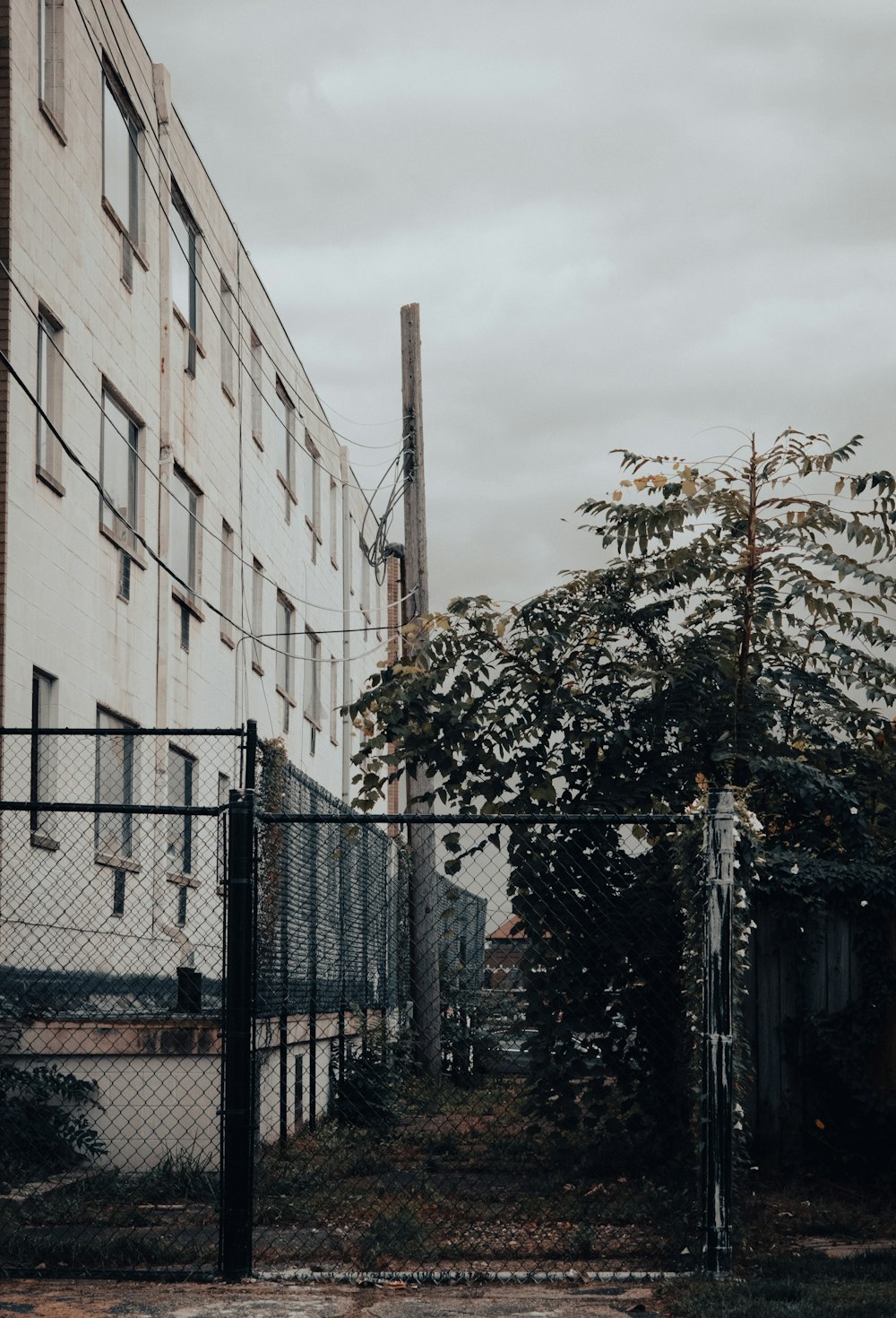 a tall building with a chain link fence around it