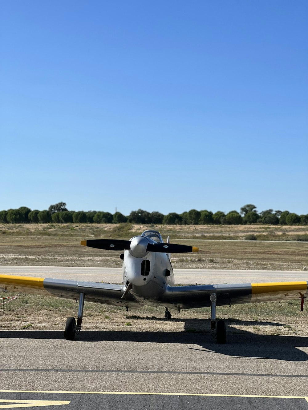 a small airplane sitting on top of an airport runway