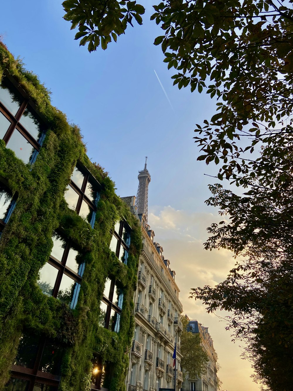 a very tall building with a clock tower in the background