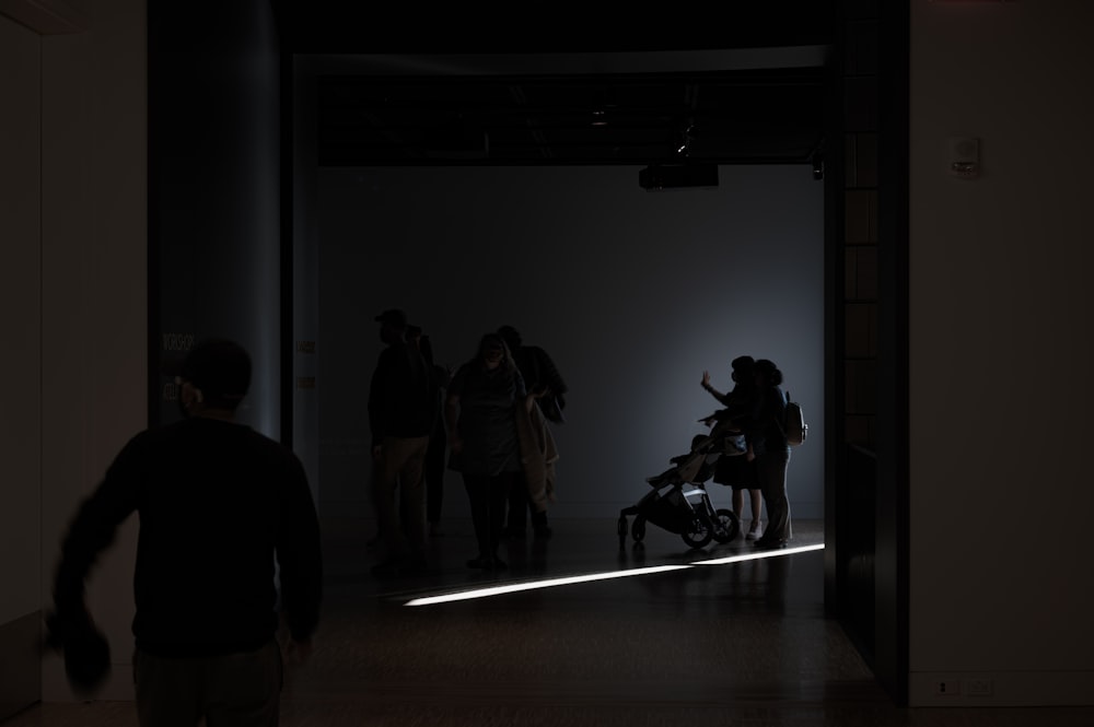 a group of people standing in a dark room