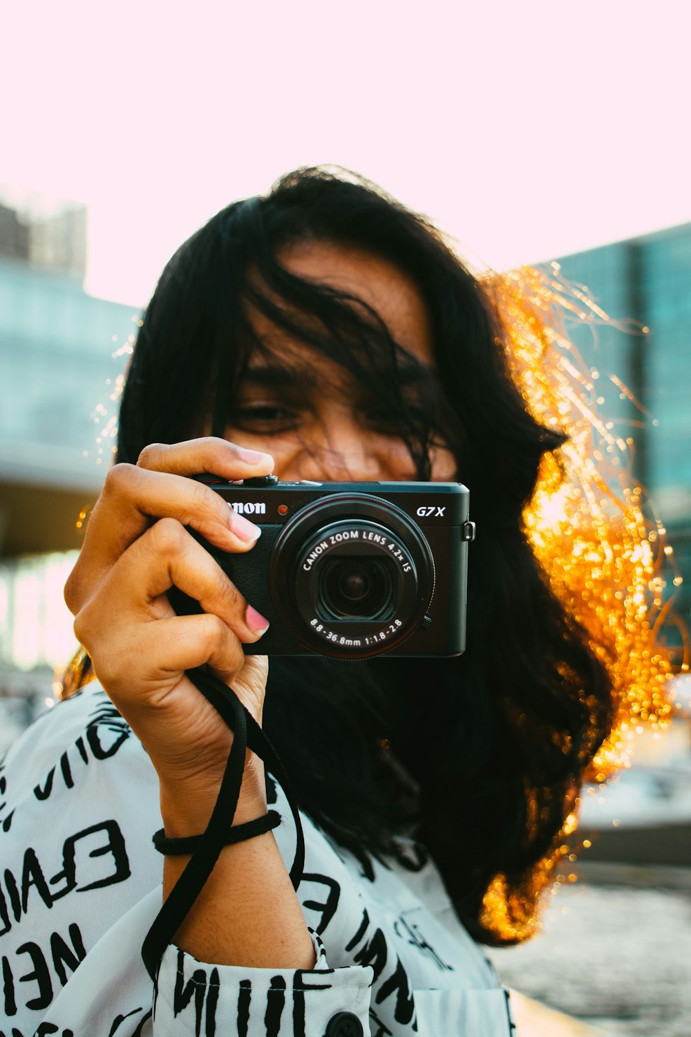 a woman taking a picture of herself with a camera